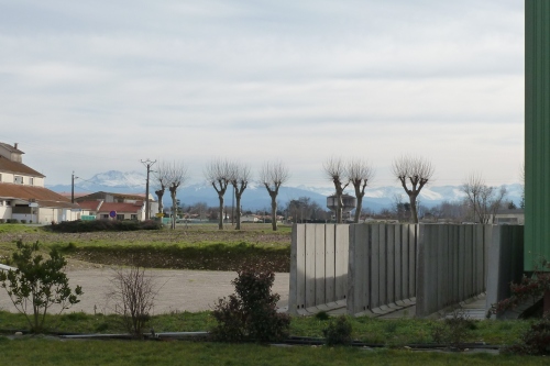 The outskirts of the now-peaceful ville, looking over where the internment camp used to be, to the mountains separating France from Spain. The water tower there is the only remaining structure.
